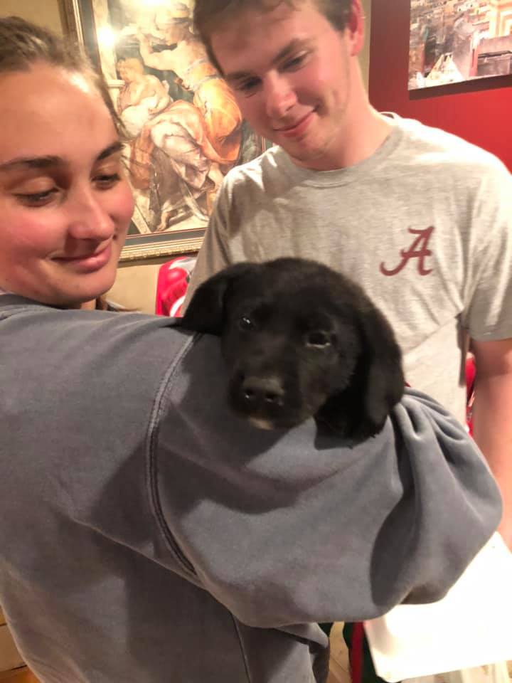 two Parker-Adams students with a puppy